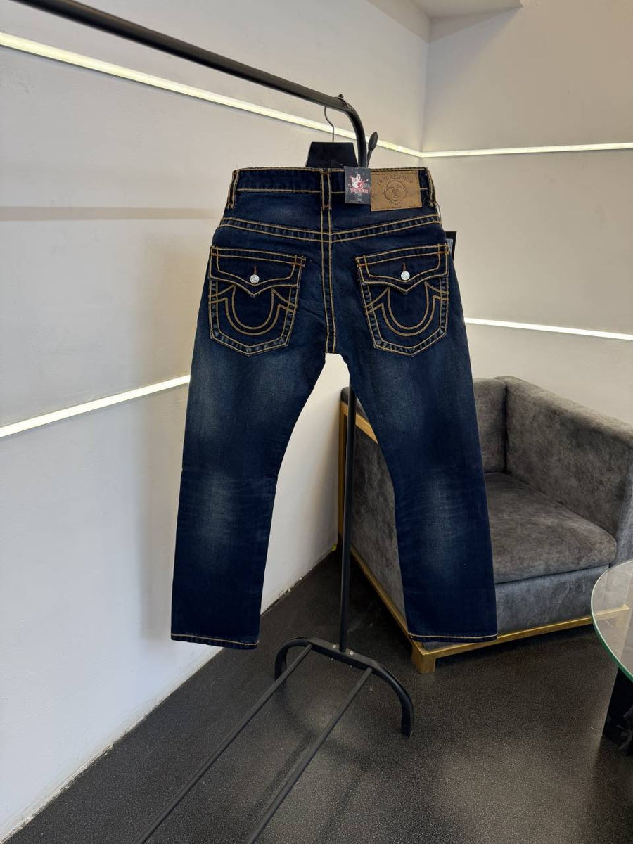 True religion hyperflex blue imported denim with brand button and pattern on back