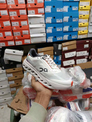 ON Cloudsurfer Next running trainers in white and red 539